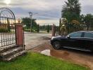 Driveway with a parked car and gate