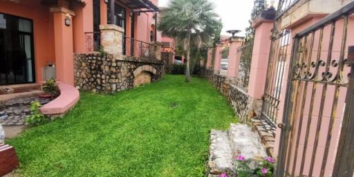 Outdoor garden area with stone pathway and greenery