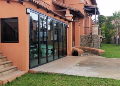 Residential building exterior with glass doors and lawn