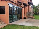 Residential building exterior with glass doors and lawn