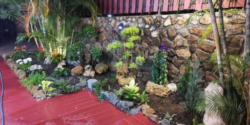 Beautifully landscaped garden with stone wall