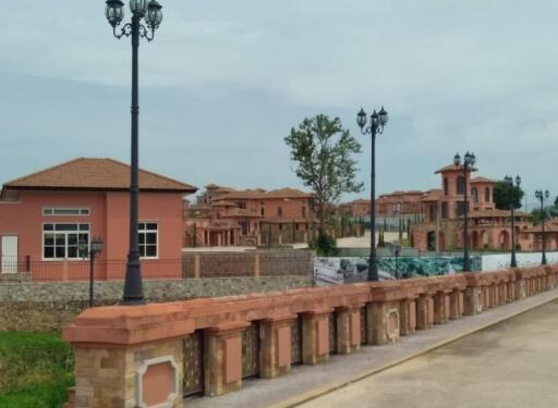 Exterior view of residential buildings with street lamps and walkway