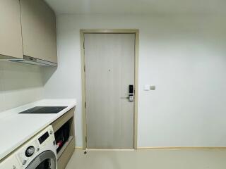 Laundry area with washing machine and storage cabinets