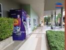 Outdoor view of a building with ATM and green plants