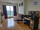 Living room with a sofa, TV, desk, and a balcony view