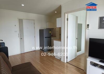 Living room with adjacent kitchen and labeled contact details for the real estate agency