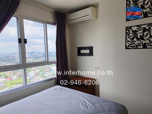 Bedroom with city view, wall-mounted air conditioner, and large window