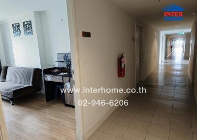 Apartment corridor with partial view of a living space