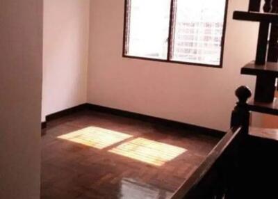 Empty room with wooden flooring and a window