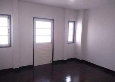 Unfurnished living room with windows and a door leading outside