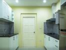 Modern kitchen with white cabinets and black countertops