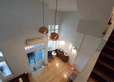 Spacious living room with modern lighting and high ceiling