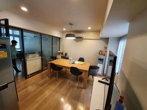 Modern dining room with wooden floor and glass wall