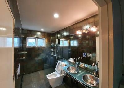Modern bathroom with double sinks and toilet