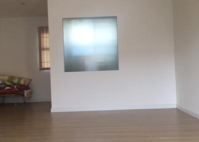 Living room with wooden flooring and frosted glass window