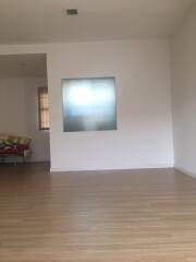 Living room with wooden flooring and frosted glass window