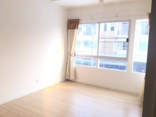 Bright living room with large windows and hardwood floors