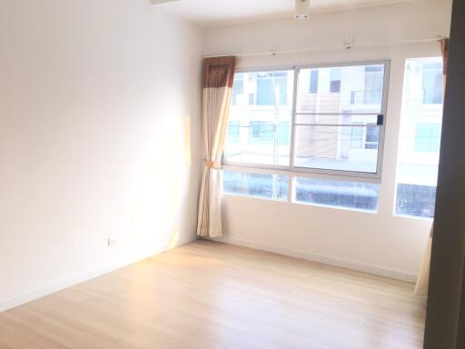 Bright living room with large windows and hardwood floors