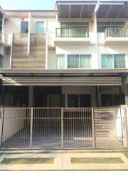 Modern multi-story residential building with gated garage