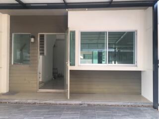 modern residential building entrance with glass door and large window