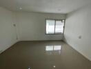 Empty room with tiled floor and window