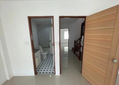 Hallway with access to bathroom and stairway