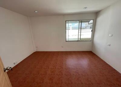 Empty bedroom with tiled floor and window