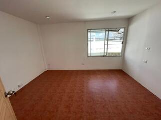 Empty bedroom with tiled floor and window