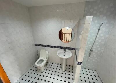 Bathroom with toilet, sink, and shower