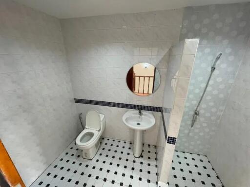 Bathroom with toilet, sink, and shower