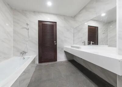 Modern bathroom with bathtub and large mirror