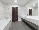 Modern bathroom with bathtub and large mirror