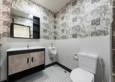 Modern bathroom with stylish wallpaper and fixtures