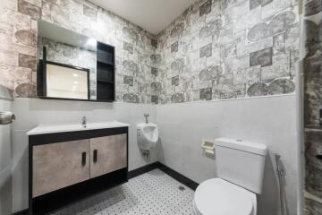 Modern bathroom with stylish wallpaper and fixtures