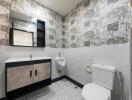 Modern bathroom with stylish wallpaper and fixtures