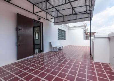 Spacious outdoor terrace with tiled flooring and seating