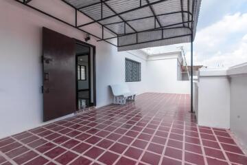 Spacious outdoor terrace with tiled flooring and seating
