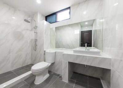 Modern bathroom with shower and large mirror