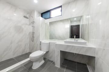 Modern bathroom with shower and large mirror