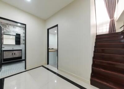 Modern hallway with access to bathroom and stairs