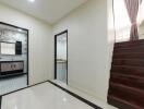 Modern hallway with access to bathroom and stairs