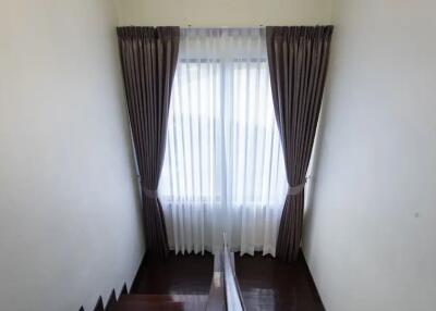 Staircase area with curtains over a window