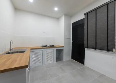 Minimalist kitchen with wooden countertop