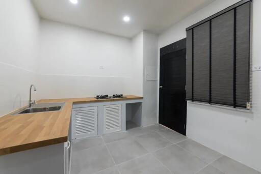 Minimalist kitchen with wooden countertop