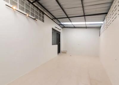 Empty room with tiled floor and metal ceiling