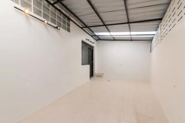 Empty room with tiled floor and metal ceiling