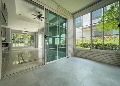 Spacious modern living area with large windows and sliding glass doors.