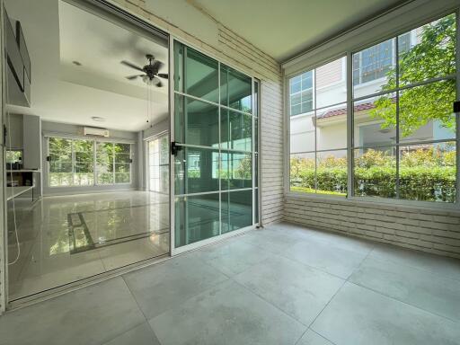 Spacious modern living area with large windows and sliding glass doors.