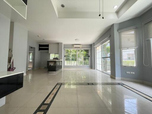 spacious living area with large windows and natural light