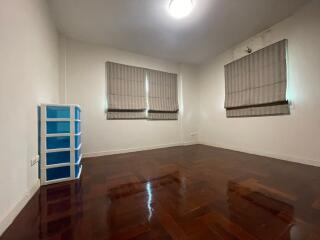 empty bedroom with hardwood floors and window blinds